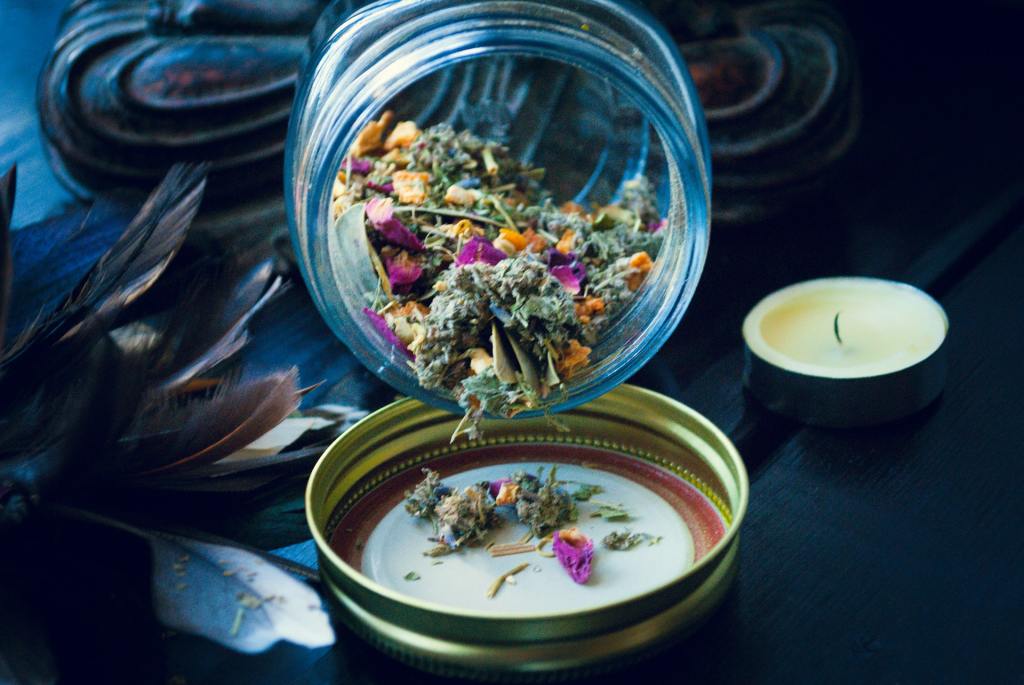 dried flowers spilling from a jar onto a lid
